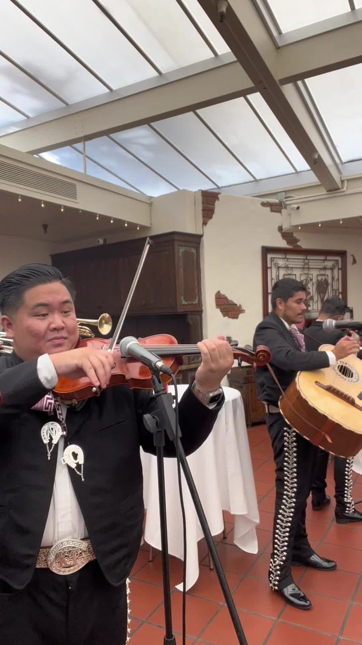 Close-up of a violinist performing at a mission-style Orange County venue